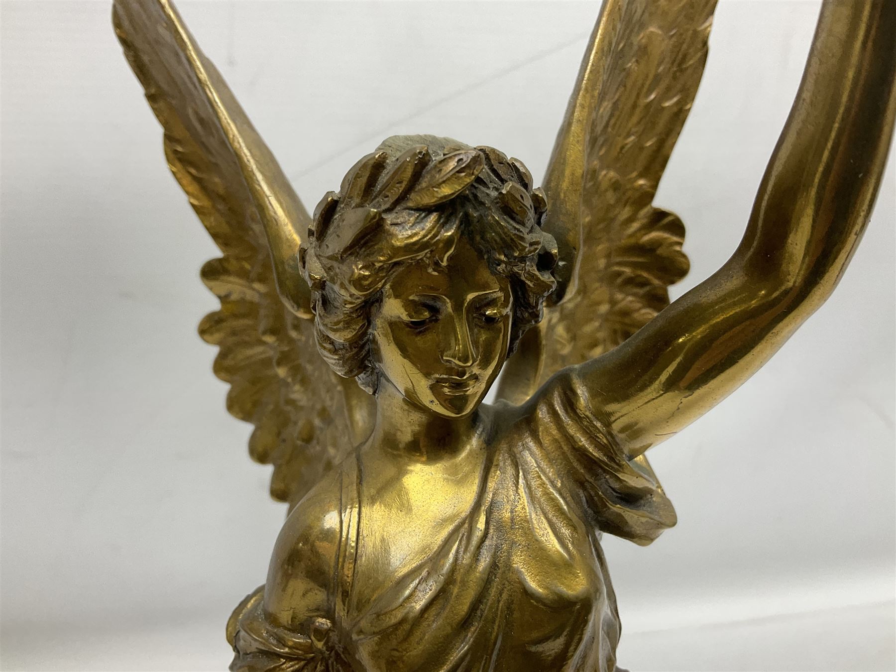 After Oswald Schimmelpfennig (German, 1872-1939): Pair of gilt bronze winged Allegorical female figures, the first example with arm outstretched holding a branch, signed 'Schimmelpfennig 1900', the second with arm raised above her head holding a book and sword in the other, both raised upon marble plinths, H45cm