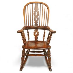Broadarm Windsor rocking chair, arched crest rail enclosing turned spindle back with pierced splat, wide shaped arms with turned supports, solid elm seat, raised on turned legs united by double stretchers, on swept rockers