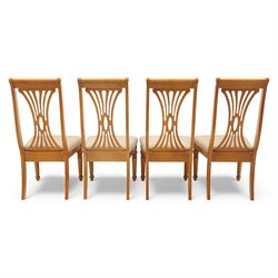 Late 20th century parquetry veneered extending dining table and eight chairs, the rectangular top with canted corners decorated with geometric parquetry panels, moulded edge frieze with repeating carved detail, raised on twin pedestal supports with fluted columns and shaped platform bases, the chairs with pierced splat backs and upholstered drop-in seats
Extends on a central leaf to 208cm