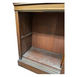 Early 19th century mahogany bookcase on cupboard, projecting cornice over four adjustable shelves, the cupboard enclosed by two sliding panelled doors, on moulded plinth base 