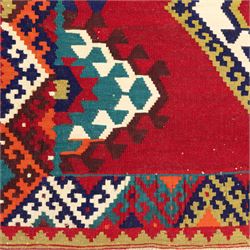 South west Persian Qashqai flatweave kilim, central field with a linked column of hooked diamond medallions in polychrome tones with an ivory lattice on a magenta ground framed by multiple geometric borders 