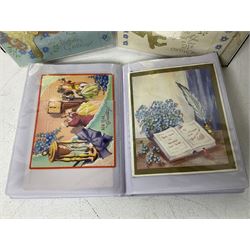 Collection of Victorian and later postcards and greeting cards, including wedding, birthday and Christmas cards, all housed within albums