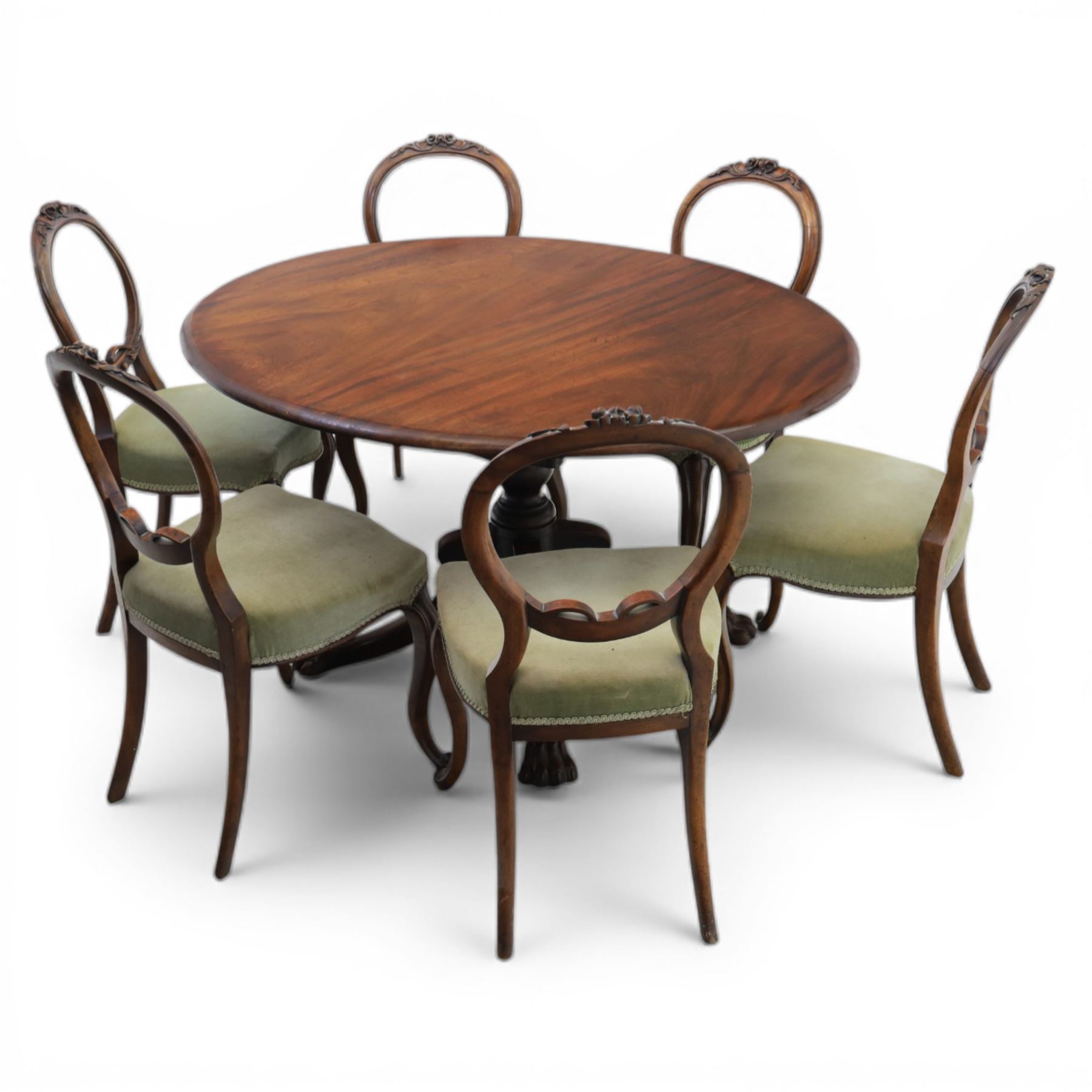 Victorian mahogany dining suite, oval tilt top dining table raised on a quatriform base with paw feet, together with a set of six balloon back dining chairs with green upholstery with cabriole legs 