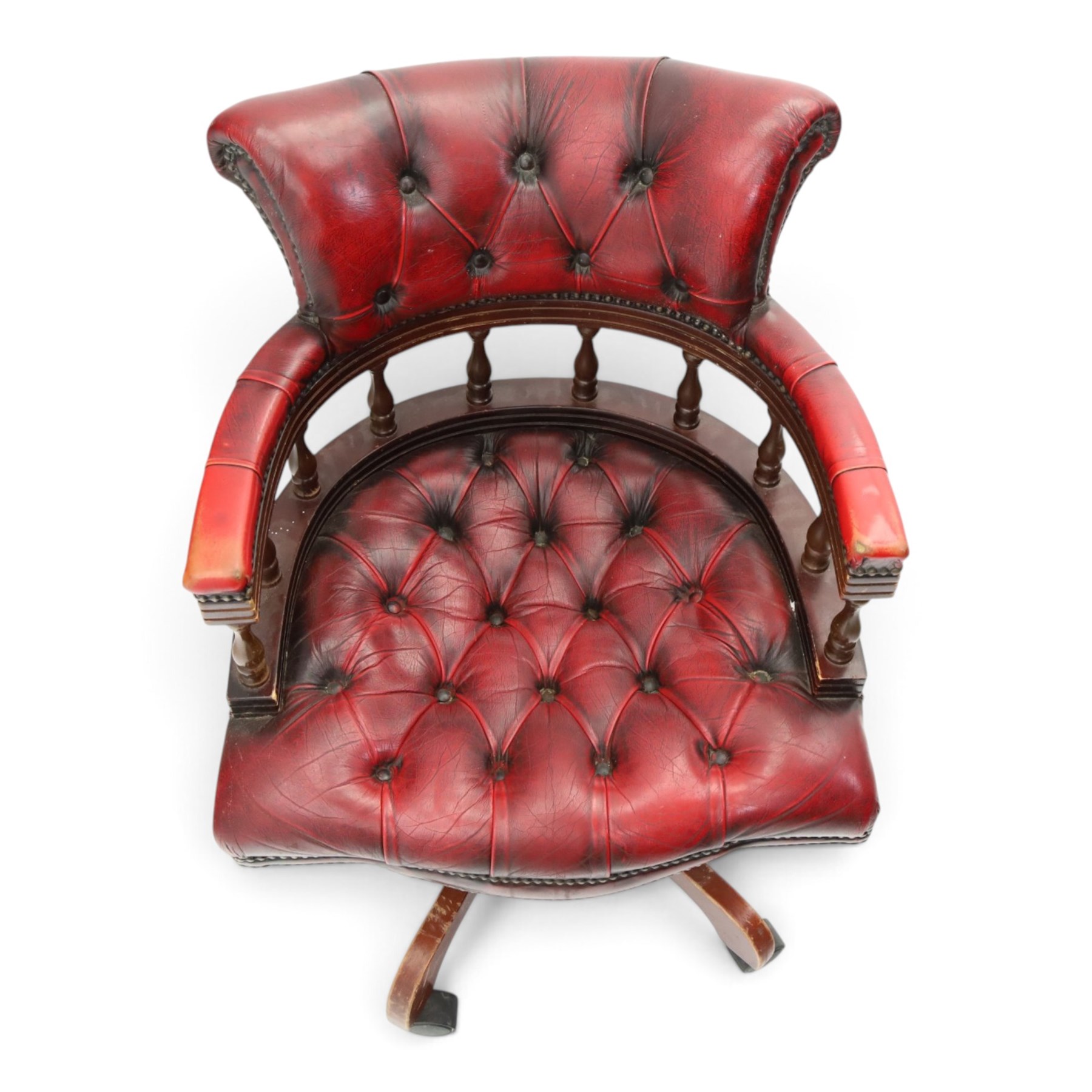 Georgian design captains swivel desk chair, rolled cresting rail over open spindle back on swivel action, upholstered in buttoned oxblood leather