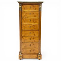 Neoclassical marble and inlaid figured maple wood tall chest, green marble inverted-breakfront top over eight long drawers, flanked by square tapering pilasters with gilt metal female bust and anthemion leaf capitals and brass feet terminals, the skirted base with applied Medusa gilt metal mounts, on compressed bun feet