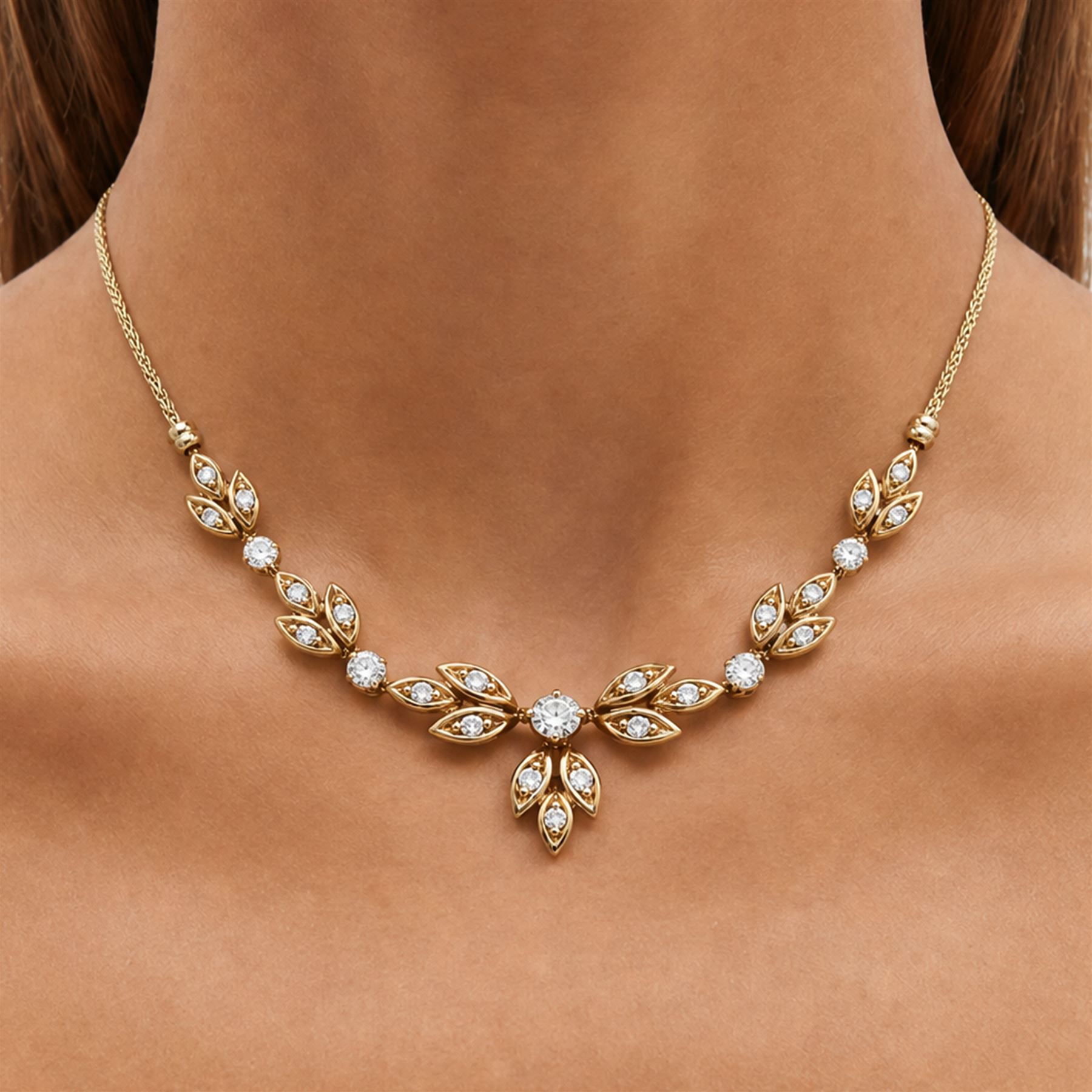 18ct gold diamond floral design necklace, five round brilliant cut diamonds, each spaced by leaf design links set with diamonds, to a Spiga link chain, Sheffield import mark 1989, total diamond weight approx 0.75 carat