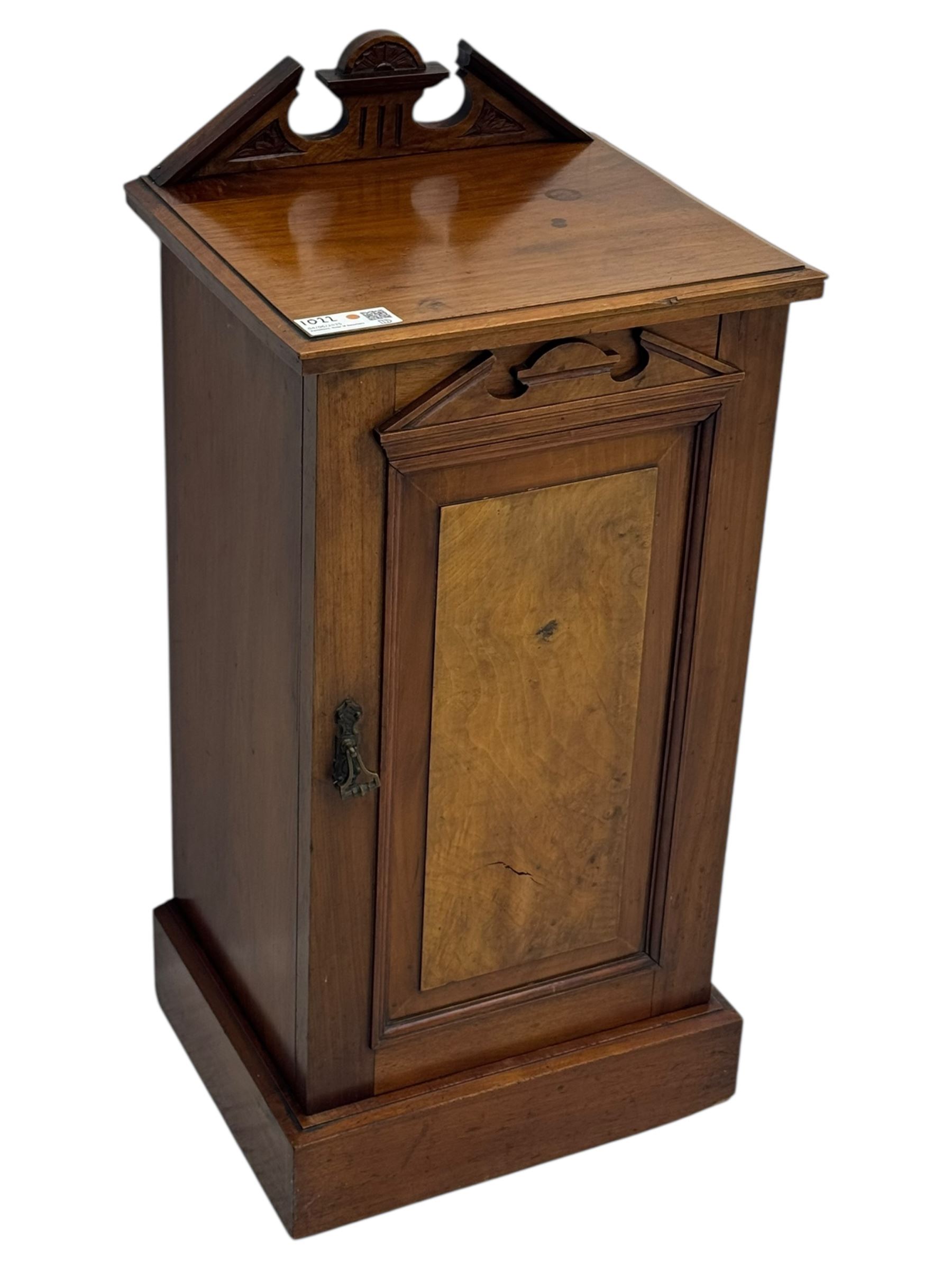 Victorian walnut bedroom suite - wardrobe, dressing chest and bedside cupboard, comprising a full-length wardrobe with broken pediment and central mirrored door, large lower drawer, a matching dressing table with bevelled swing mirror over two trinket drawers and two short drawers over two long drawers, and a single-door bedside cupboard, all with moulded edges, decorative panel work and shaped aprons