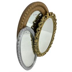 Early 20th century oval gilt framed wall mirror (85cm x 54cm); gilt framed oval mirror decorated with scrolling foliage (72cm x 47cm); and a silvered oval wall mirror (67cm x 36cm)