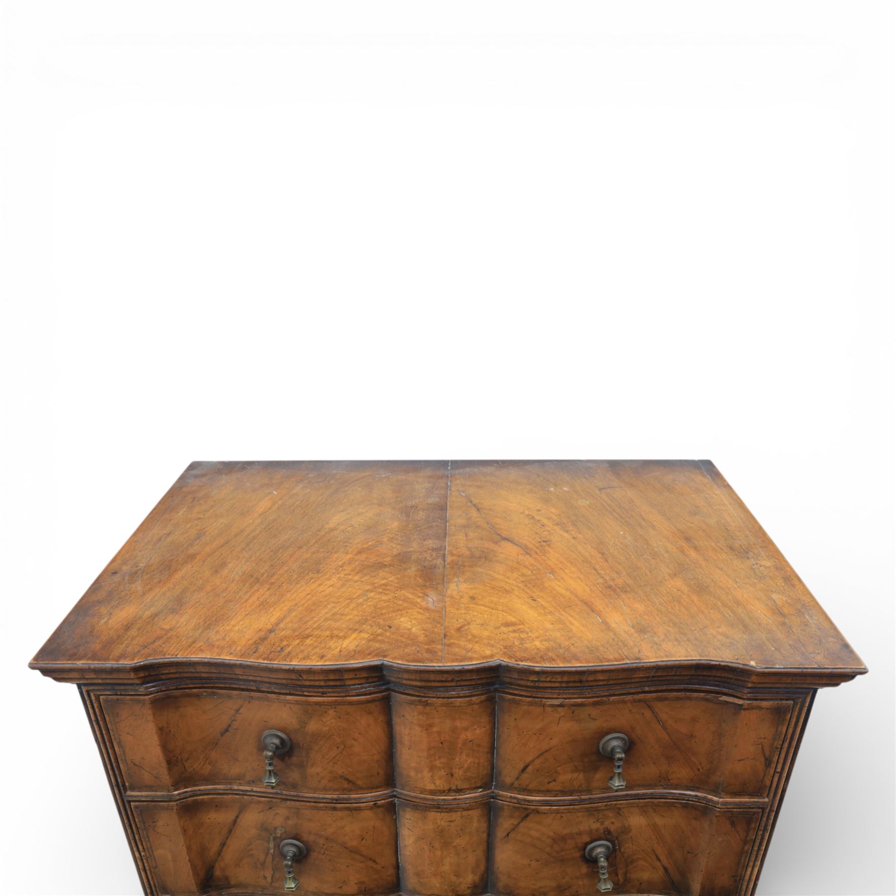 Early 20th century Queen Anne revival walnut chest on chest, the shaped cornice over an arrangement of four long drawers above three further long drawers, figured walnut veneers with feather banding and crossbanding, on turned bun supports