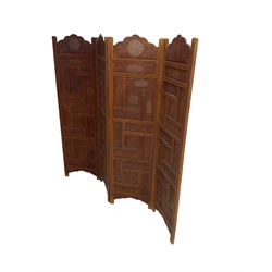 Indian heavily carved hardwood four panel screen, each fold comprised of rectangular panels pierced and carved with scrolling flower heads and floral decoration, each panel W51cm H187cm