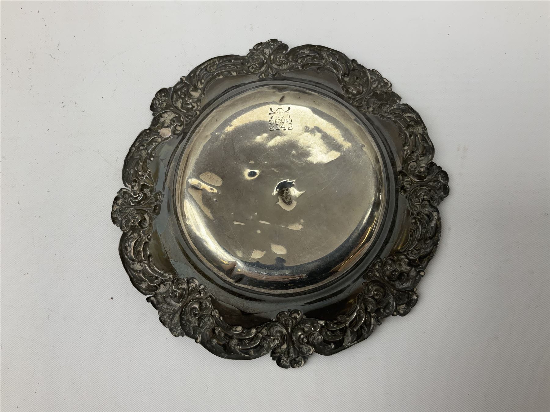 Small silver dish with repousse scrolling edge, stamped Sterling, together with a pair of Danish silver spoons, approximate total weight 61.4 grams
