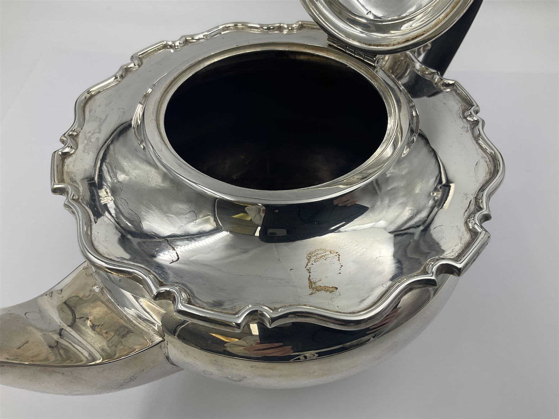 1920s five-piece silver tea service, comprising teapot, coffee pot, hot water pot, twin handled open sucrier and milk jug, each of squat circular form with shaped rim, the teapot, coffee pot and hot water pot each with ebonised handle and finial, the sucrier and milk jug with acanthus capped scroll handles, all upon circular foot, hallmarked R F Mosley & Co, Sheffield 1926 & 1927, tallest H24cm