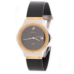 Hublot MDM Classic gentleman's 18ct gold and stainless steel quartz wristwatch, Ref. 1523.2, black dial with date aperture, on rubber strap with fold-over clasp, boxed with guarantee card dated 2004