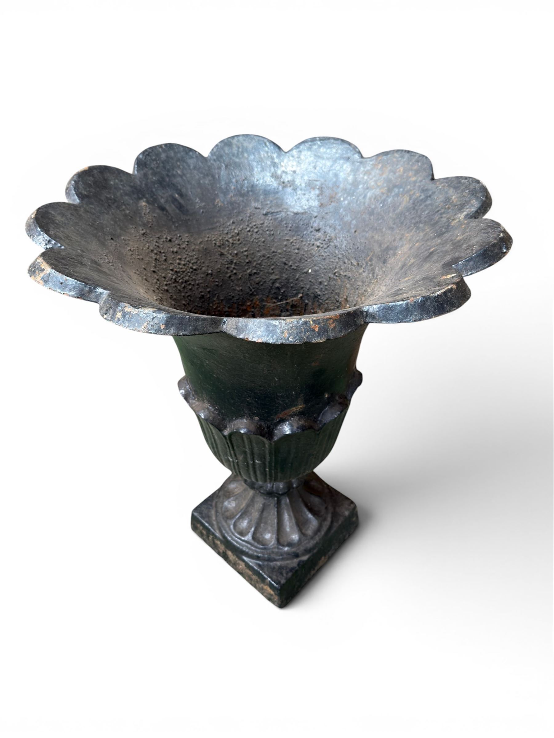 Pair of Victorian large scale cast iron garden urns, flared petal shaped rim with tapering waist, gadrooned base on square plinth, finished in black paint