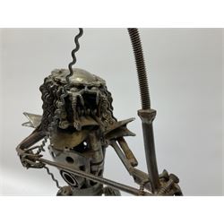 Predator metal sculpture, made with scrap metal, with articulated body, bike chain hair, and bow and arrow, H45cm