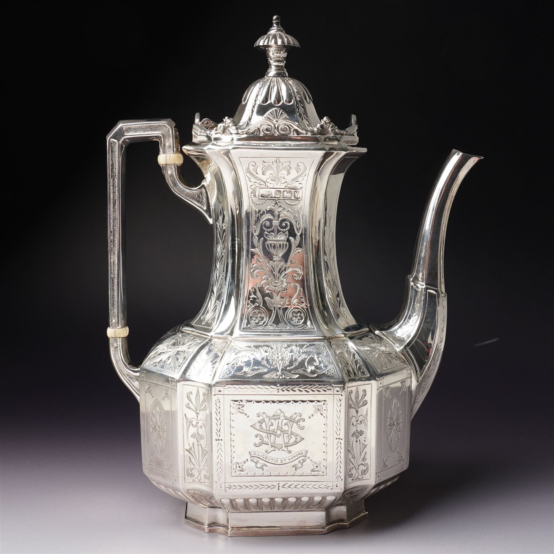 Victorian silver tea and coffee set engraved with classical urns, oval paterae and scrolling foliage, monogram and 'Diligentia et Honore' comprising teapot, tea kettle on spirit heater stand, coffee pot, two handled sugar bowl and cream jug Sheffield 1891 Maker John Round & Son Ltd
