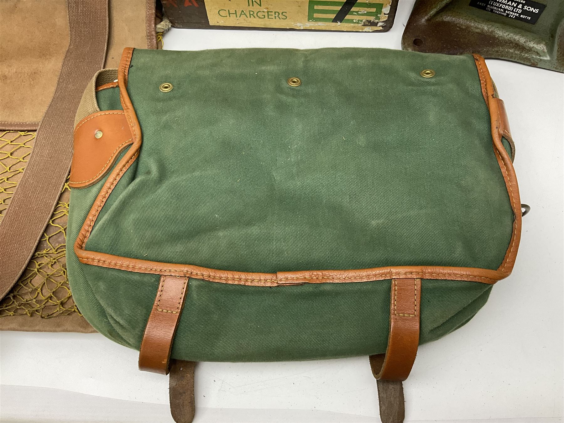 Miscellaneous shooting accessories - W.J. Bowman & Sons clay pigeon launcher; two leather cartridge belts; three cartridge bags; two canvas/leather game bags; and two metal/wooden cartridge boxes