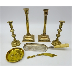  Pair 18th century bronze candlesticks, pair 19th century brass candlesticks, Victorian silver-plate crumb scoop with belt entwined reeded carved ivory handle, Trench Art paper knife and Bulldog & Union Jack embossed brass pin dish (7)  