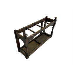 Edwardian oak hallway stick and umbrella stand, four divisions on turned supports, with metal tray liners and various sticks