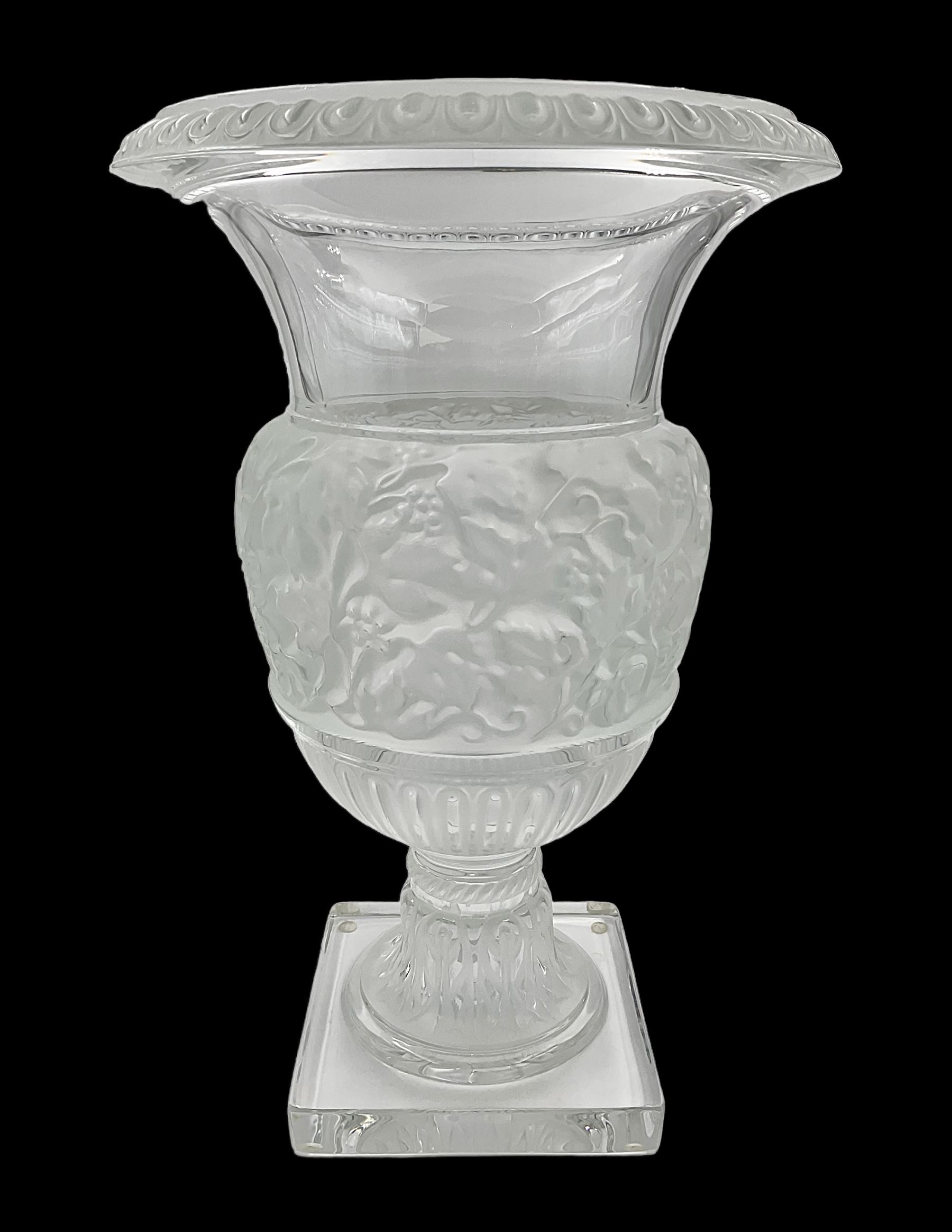 Large and impressive Lalique Versailles pattern glass vase, of classical baluster form with gadrooned flared rim, the body moulded in relief with fruiting vines above part fluting, upon a spreading circular foot with moulded decoration, and plain square plinth base, signed Lalique France to side of plinth, overall H35cm, with original box 