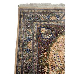 Persian design peach ground rug, tree of life design with trailing leafy branches and decorated with flower heads, scrolled spandrels with stylised plant motifs, guarded border with repeating floral pattern 