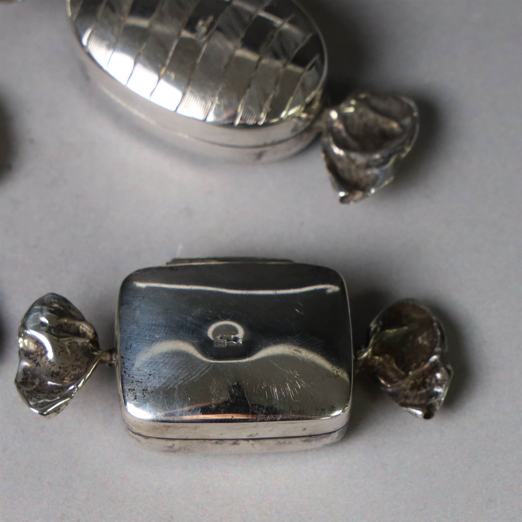 Four novelty silver pill boxes, in the form of wrapped sweets, all hallmarked, largest W6cm