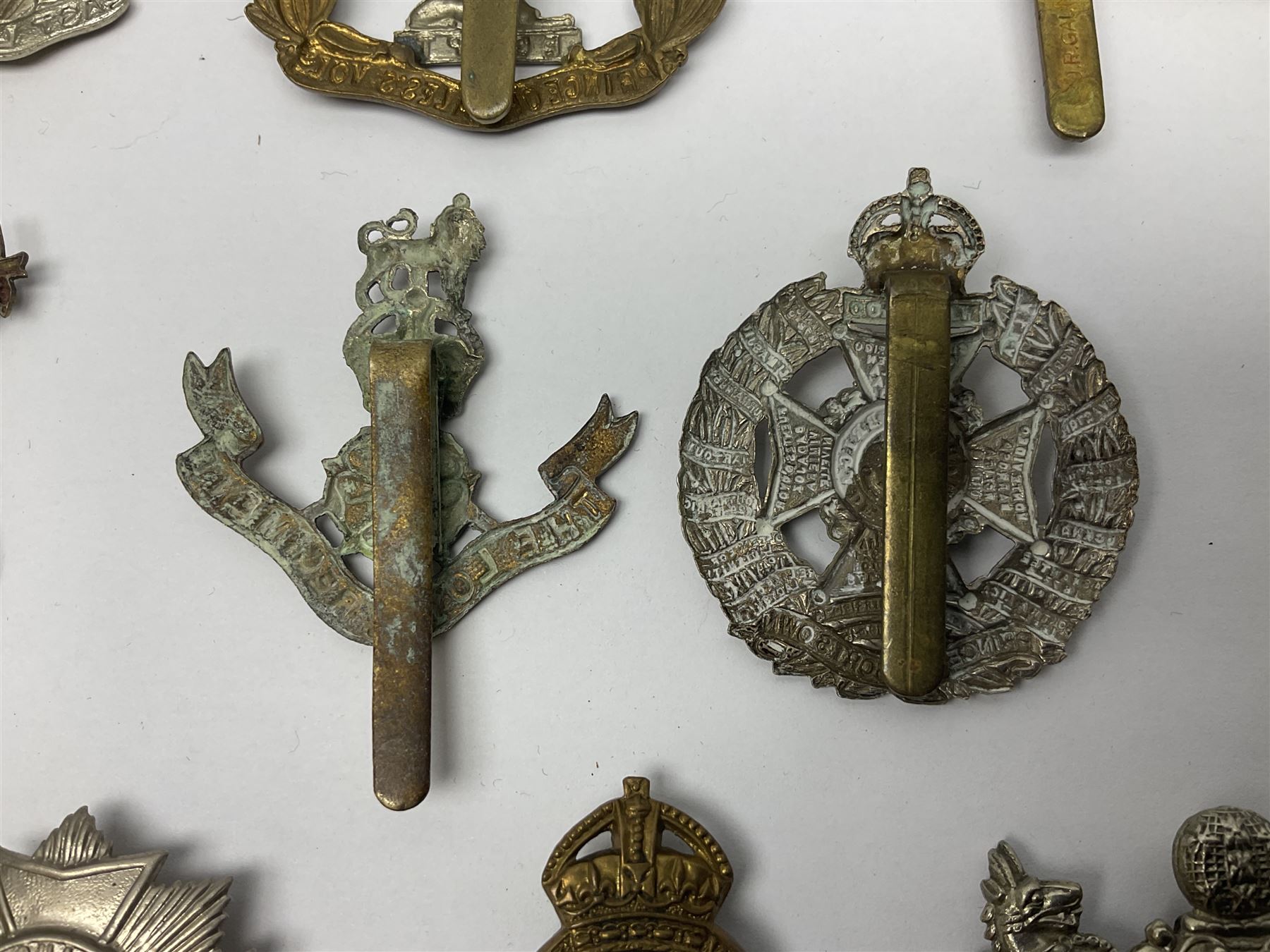 Twenty cap badges including Hertfordshire, Royal Sussex, Cambridgeshire, Hampshire, Notts and Derby, East Surrey, Herefordshire, South Lancashire, Devonshire, Bedfordshire, Durham Light Infantry etc (20)