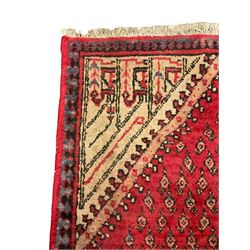 Small Persian red ground rug, lozenge medallion surrounded by small Boteh motifs
