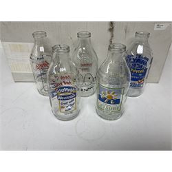 Twenty one vintage advertising milk bottles