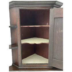19th century oak wall hanging corner cupboard, single panelled cupboard with shell motif, three shelves to either side