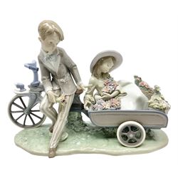 Lladro figure, Country Ride, modelled as a boy on a bike and a seated girl with flowers, sculpted by Francisco Polope, no 5958, with original box, year issued 1993, year retired 2004, H29cm