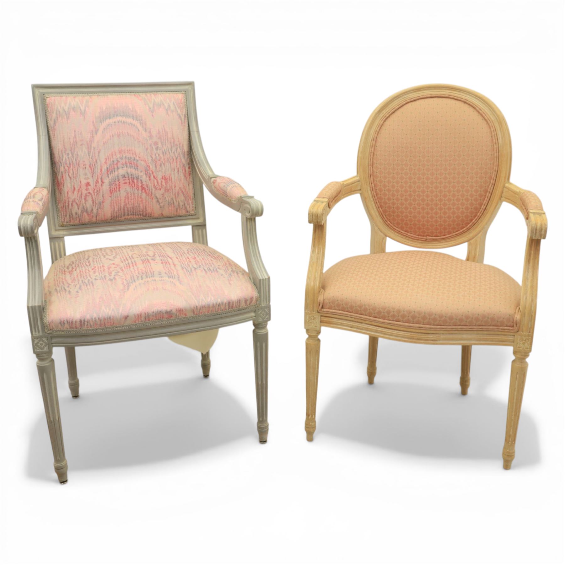 Set of two French design fauteuil armchairs upholstered in pink fabric, one with oval medallion back and padded arms on fluted tapering supports (H 97cm, W 58cm, D 54cm), the other with rectangular padded back, scroll arms and fluted tapering supports (H 99cm, W 60cm, D 60cm)