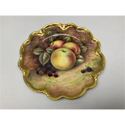 Set of four 20th century Coalport cabinet plates decorated by Richard Budd, each of circular form with shaped rim, hand painted with a still life of fruit upon a mossy ground signed R Budd, with blue printed marks beneath, D23cm