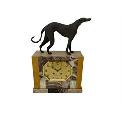 A 20th century French Art Deco clock garniture with a movement by Pierre Megin of Seloncourt, in  a rectangular case with panels of contrasting variegated marble surmounted by a sculpted figure of a greyhound, with a stylised octagonal dial within a glazed bezel, with Arabic numerals, minute markers, steel hands and the retailers name “Raoul Nion, Bauge” inscribed on the dial, with an eight-day Parisian countwheel striking movement, striking the hours and half hours on a bell (missing), with a pair of corresponding garnitures. With pendulum. 





