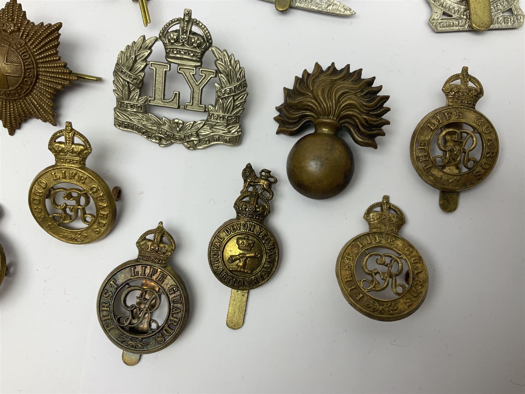 Twenty-six cap badges for Yeomanry and various guards including Fife & Forfar, Lothian and Border Horse, Leicestershire, Northamptonshire, Queens Own, Coldstream, Grenadier, Machine Gun Regiment, Life Guards etc (26)