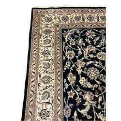 Central Persian part silk indigo ground Nain carpet, the field decorated with interlacing leafy branches and stylised plant motifs, scrolling design border within guard stripes 