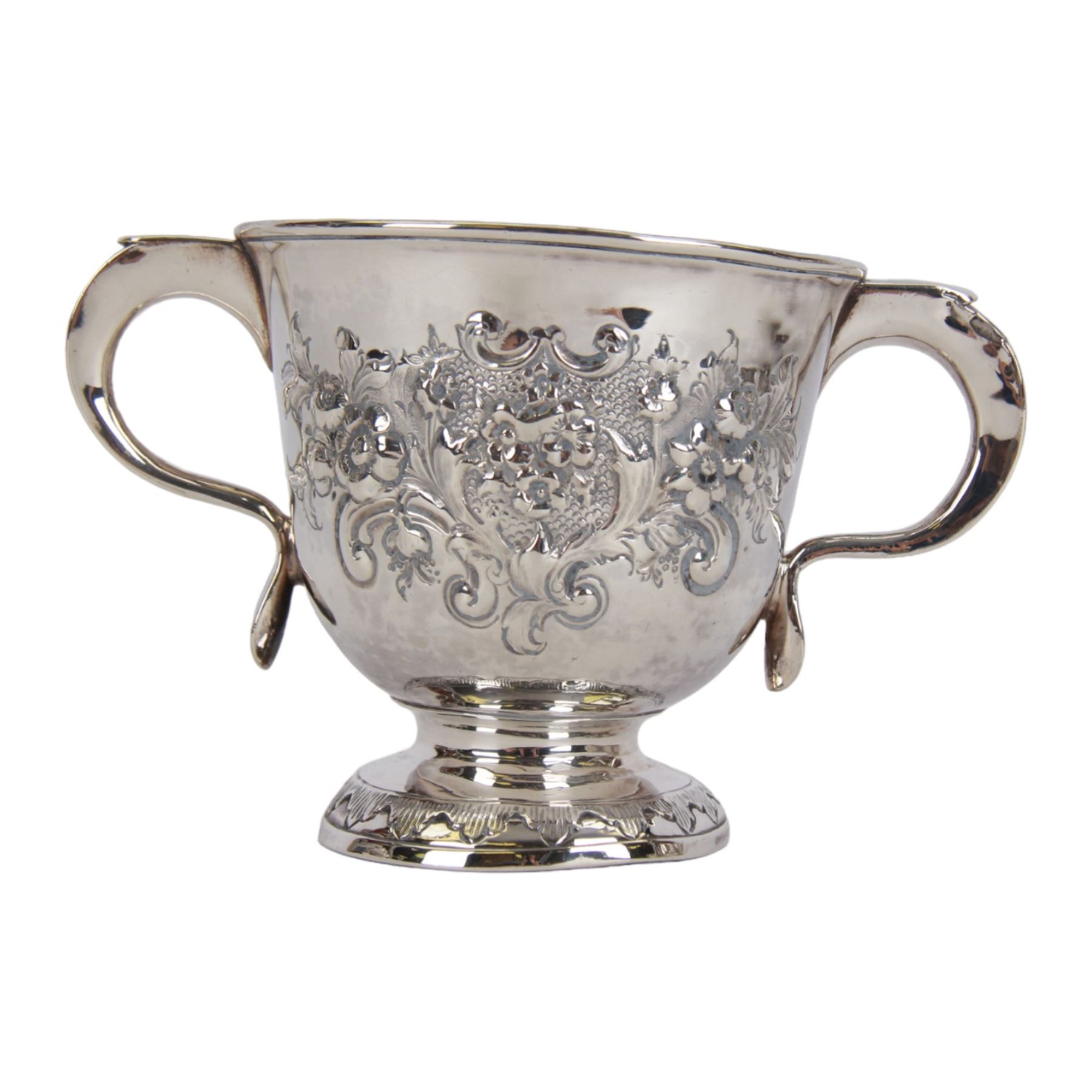 George I silver porringer, of typical form with flat capped twin curved handles,  the body with later presentation engraving surrounded by later embossed foliate decoration, upon a spreading circular foot, hallmarked Sarah Holaday, London 1723, H10.5cm