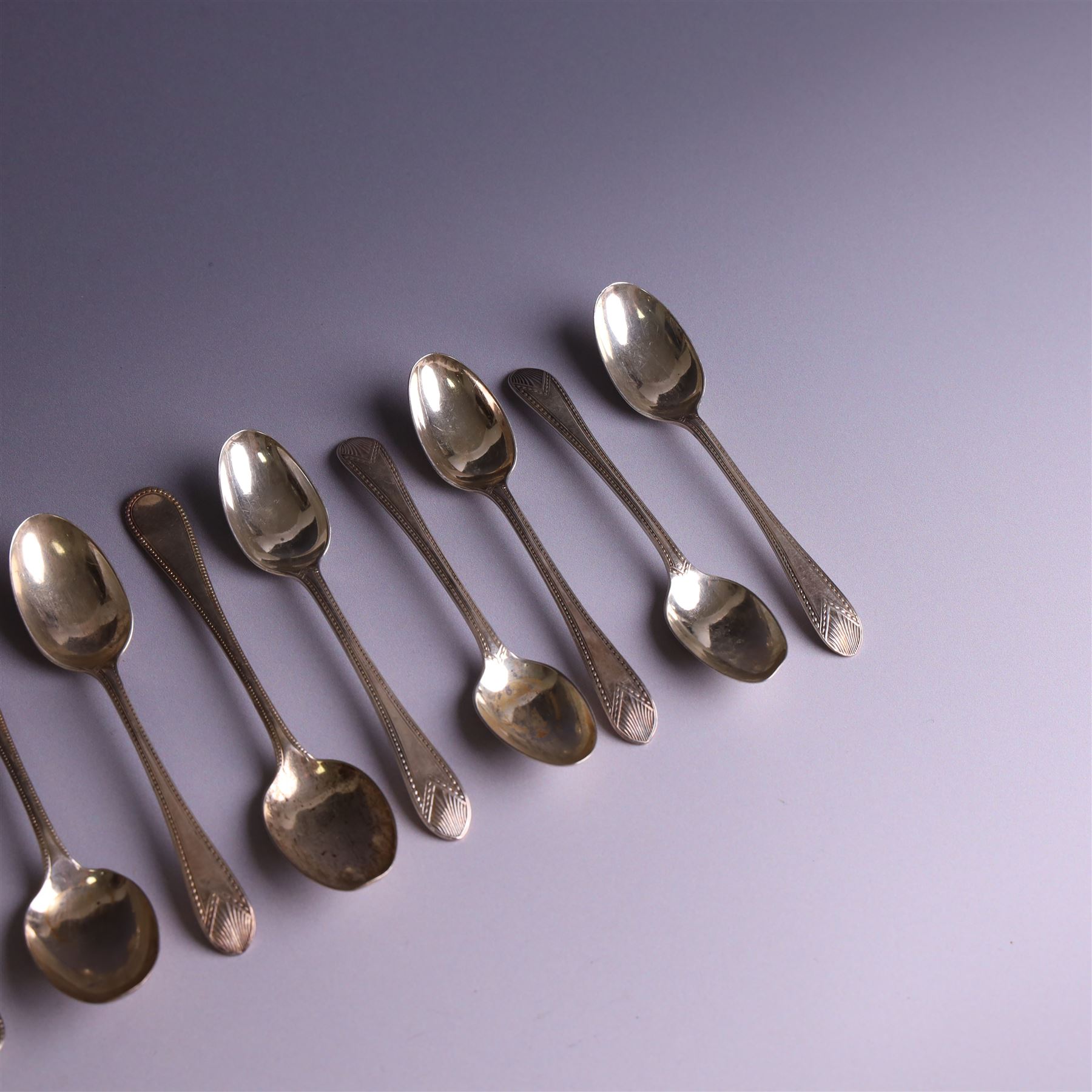 Set of ten silver late Victorian silver teaspoons, with beaded rimg and engraved fan design, hallmarked Thomas Bradbury & Sons, London 1891, and a set of five Victorian silver teaspoons with beaded rim, hallmarked Thomas Prime & Son, Birmingham 1890