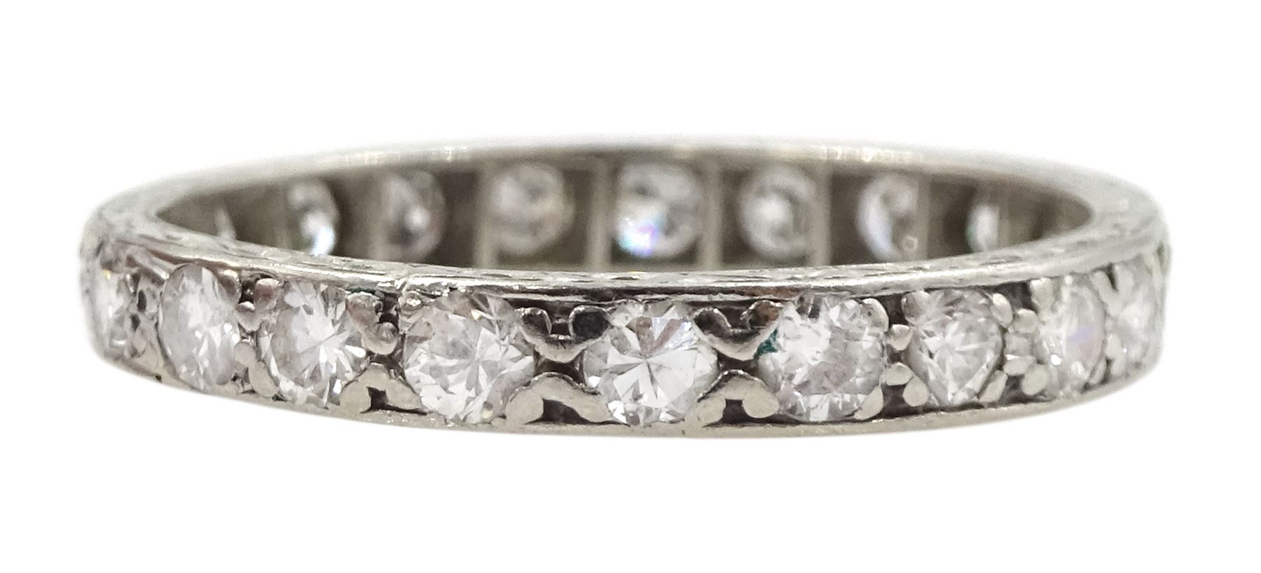 Early-mid 20th century platinum channel set diamond full eternity ring, the band with engraved decoration, total diamond weight approx 0.90 carat