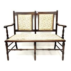 Late Victorian mahogany framed two seat settee, upholstered seat and back in floral fabric, turned supports joined by stretcher 