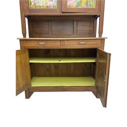 Early to mid-20th century oak dresser, glazed cabinet over two drawers and cupboards, the doors carved with flower heads
