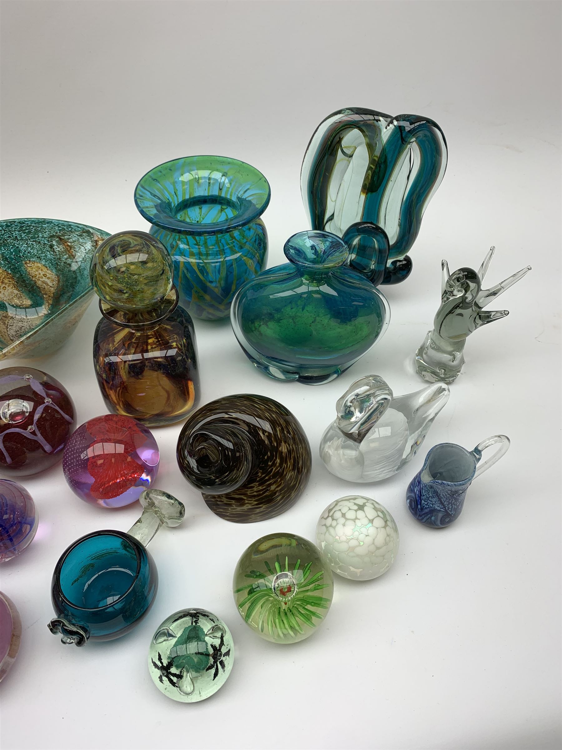 Mdina glass comprising a sculptural glass paperweight, bottle and stopper, vase of teardrop form, two vases and a dish, together with various paperweights including Caithness, vases etc 