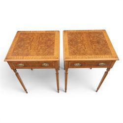 Traditional design pair of walnut lamp tables, figured top with crossbanded edge, above a single frieze drawer with brass oval handles, raised on turned supports