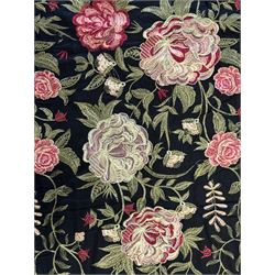 Embroidered Karandi fabric runner, the field featuring a black ground with an all-over floral design, including large pink and cream roses, accompanied by green leaves and small blossoms, bordered by plain sections at each end