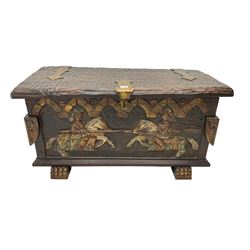 Carved wooden blanket chest, the tooled hinged lid with shaped metal strap hinges and catch, the front carved with arcade over two medieval jousters, on carved sledge feet