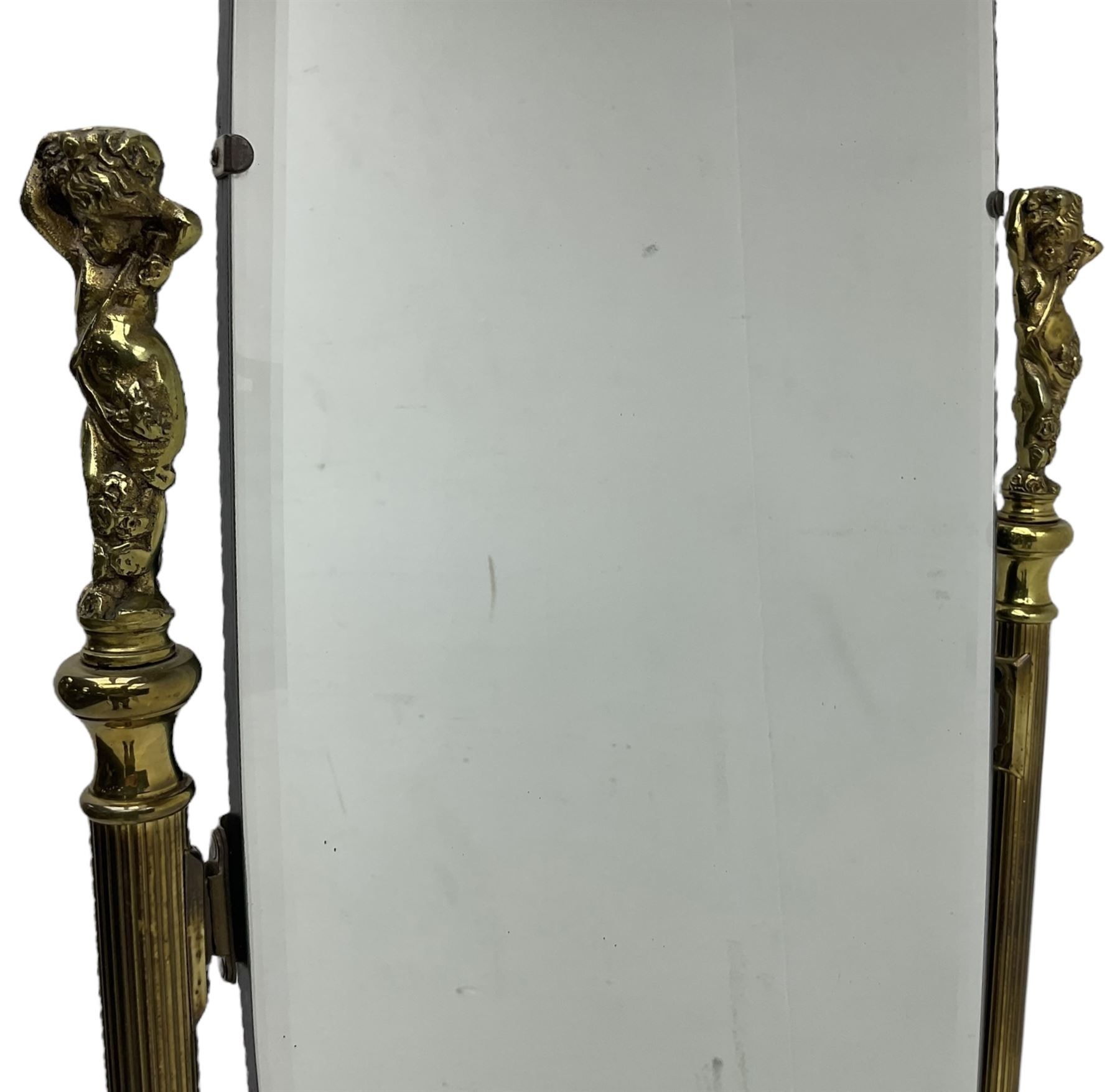 Late 20th century gilt metal cheval mirror, oval bevelled mirror on reeded supports with putti finials 