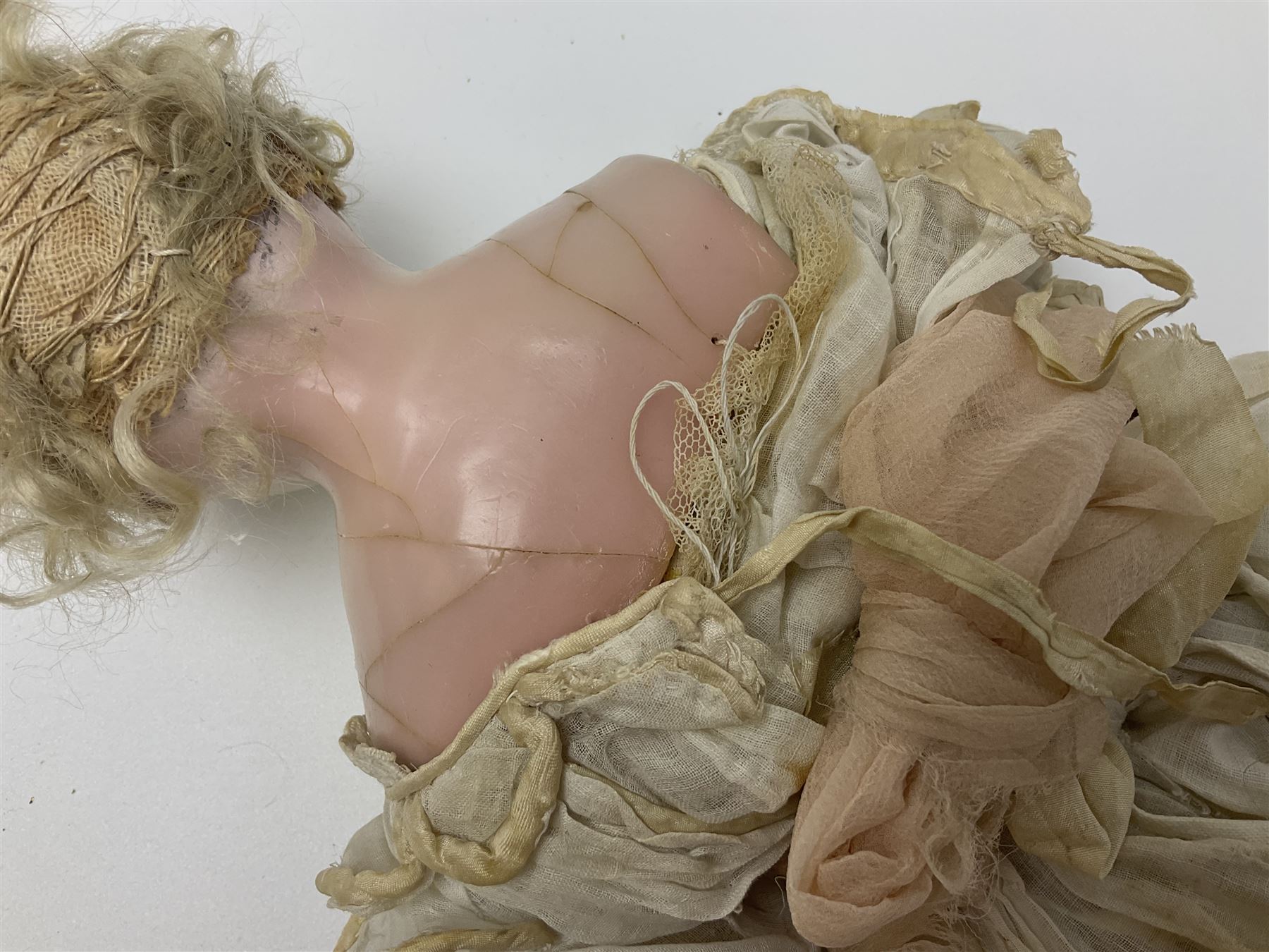 Victorian wax shoulder head doll with pale complexion, applied hair, inset glass eyes and fabric covered jointed body with kid leather lower arms; white linen dress and undergarments H50cm