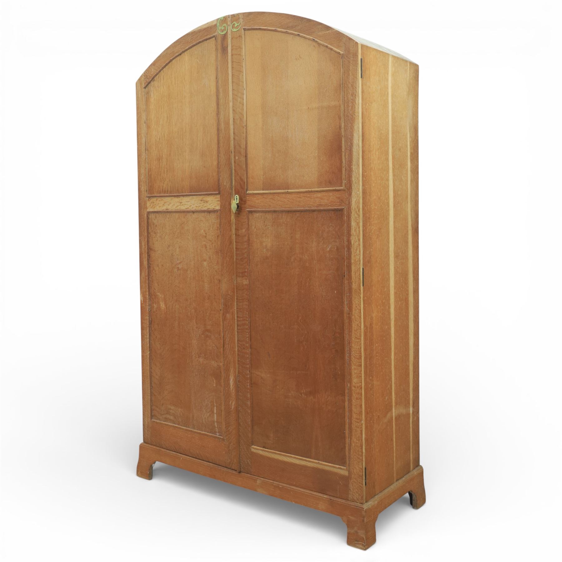 Early 20th century Art Deco bedroom suite, comprising double wardrobe, dressing table and chest of drawers, constructed in walnut with figured veneers and geometric banding, the wardrobe with arched top and panelled doors enclosing a fitted interior, the dressing table with rectangular top below a three panel mirror arrangement, fitted with two short over two long drawers, the chest with three short and three long drawers, each piece fitted with faceted handles and raised on shaped feet
Wardrobe (H 177cm, D 46cm, W 112cm)
Chest (H 85cm, D 48cm, W 92cm)
Dressing table (H 160cm, D 52cm, W 106cm)
