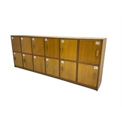 20th century oak bank of lockers, fitted with eight locker cupboard doors each enclosing single shelf, on plinth base