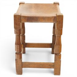Mouseman - 1950s dark oak dressing table stool, the rectangular top with tan leather seat, raised on octagonal supports united by box stretcher, carved with mouse signature, by the workshop of Robert Thompson of Kilburn